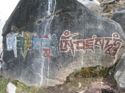 Om Mane Padme Hum characters in tibetan script carved on a rock outside the Potsala Palace